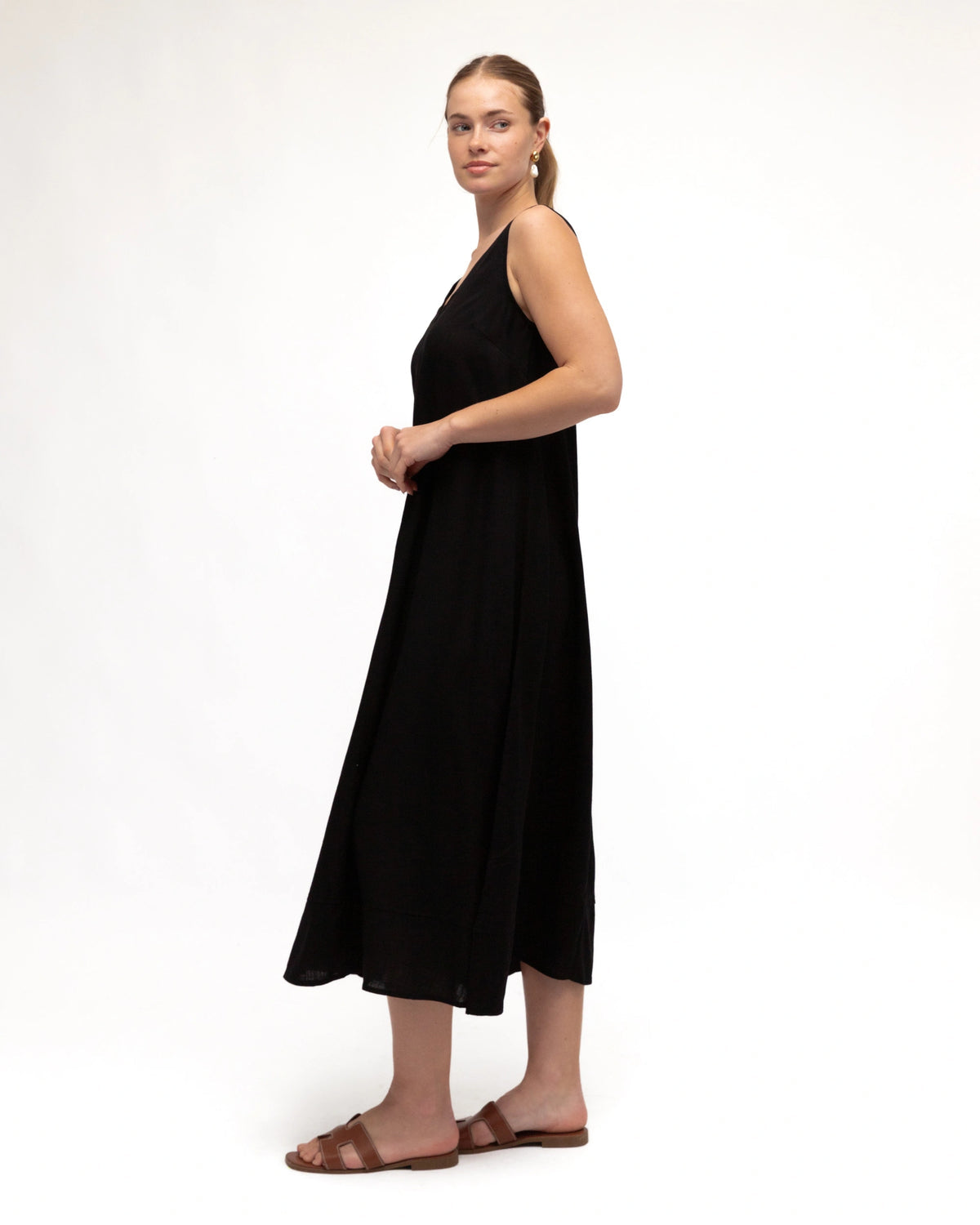 Woman wearing a black dress on a white background